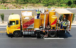 Heavy-duty thermoplastic road marking vehicle performing long-distance line painting on city roads