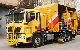 Side view of a high-capacity thermoplastic road marking vehicle for large-scale infrastructure projects