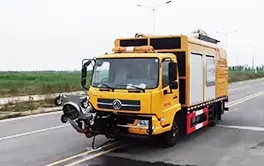 Truck-mounted road line removal equipment with integrated vacuum system for immediate debris cleanup