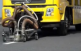 Close-up of the specialized grinding heads on a road marking removal truck for thorough line stripping