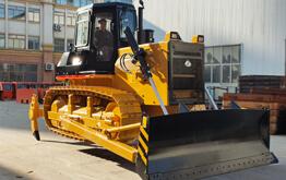 Yellow crawler bulldozer working on a large scale project site