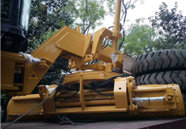 Motor grader attachments including front dozer and rear ripper